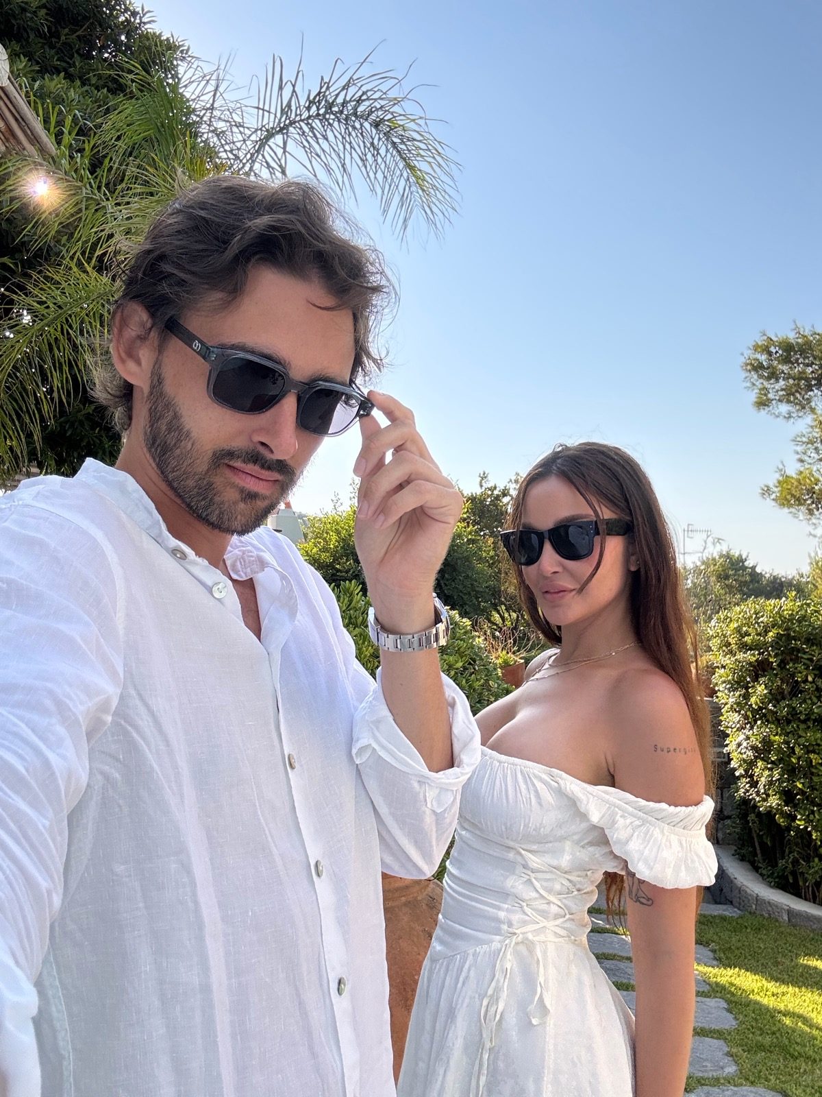 Selfie of the two of us in white in the hotel garden